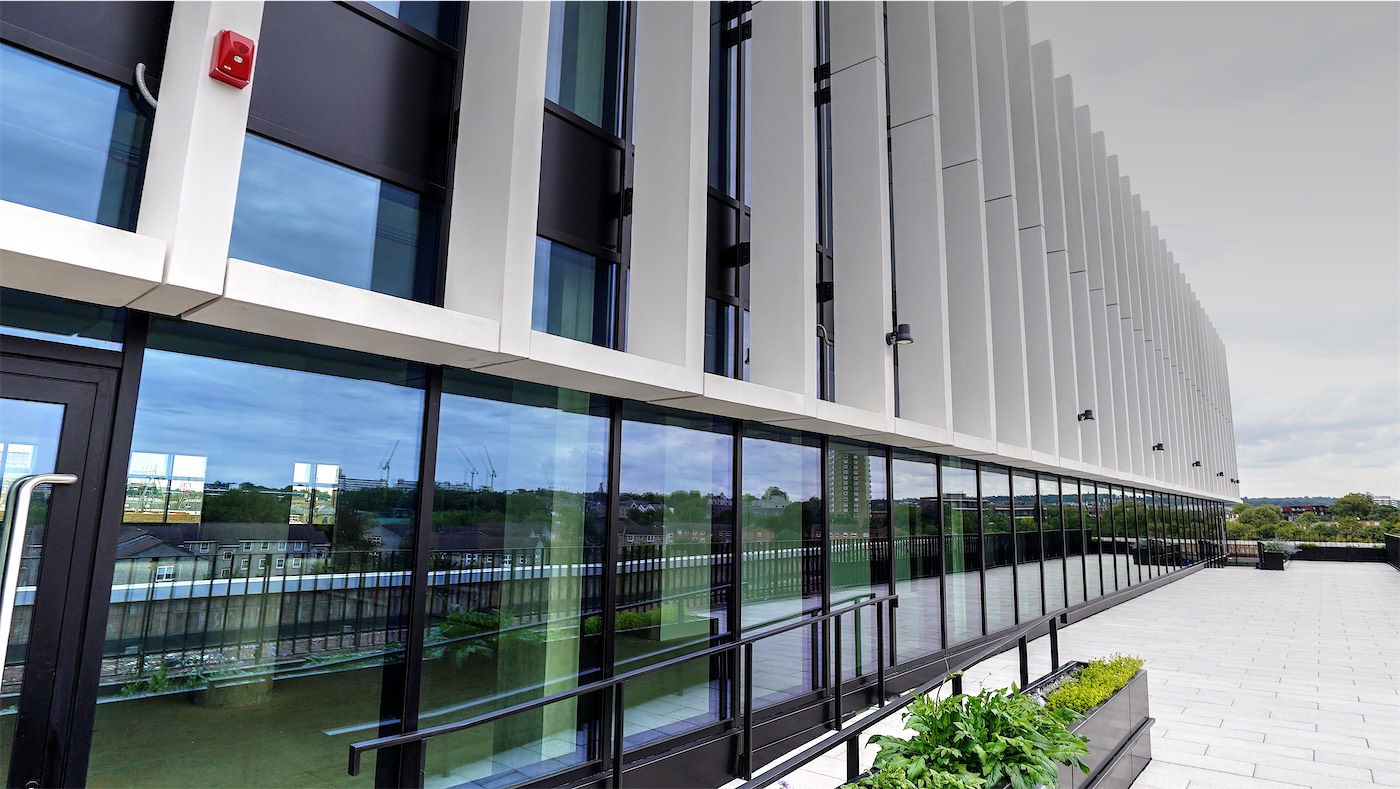 Roof terrace with glazing and white fins receding.