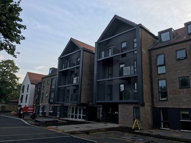 Later-living apartment blocks with dark gabled bays for McCarthy & Stone in Guildford